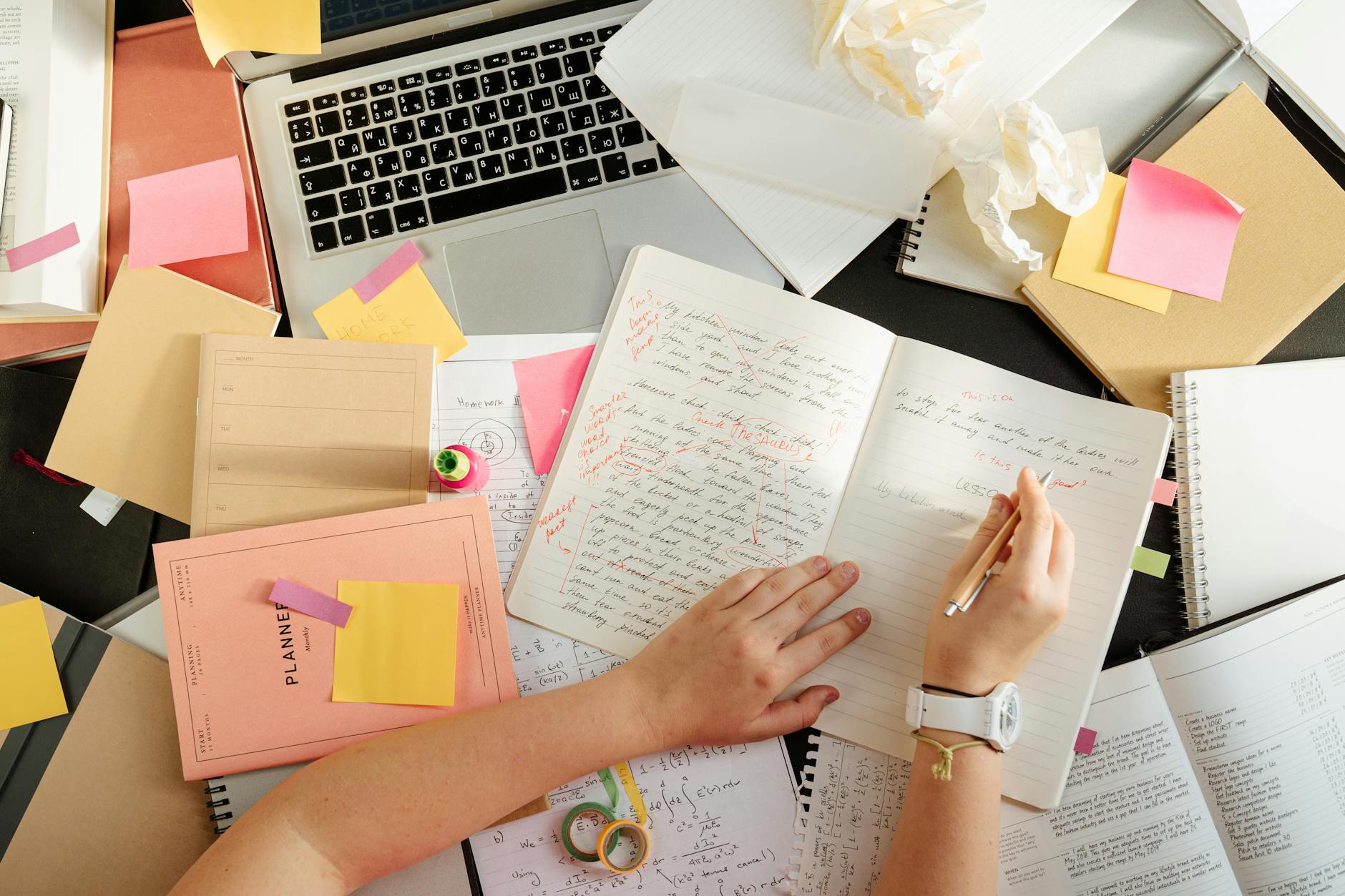 person writing on a notebook